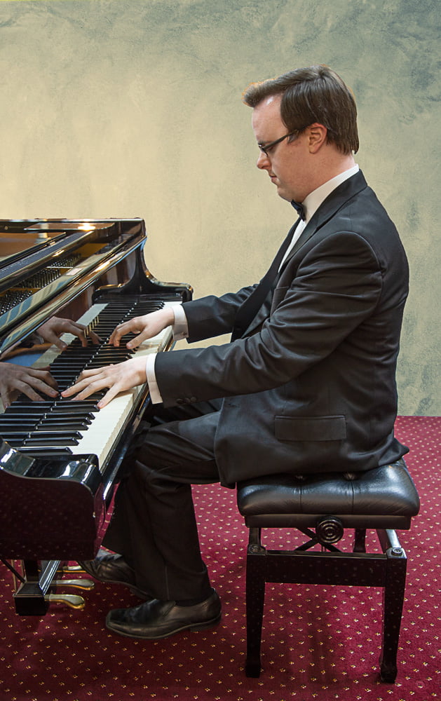 profile shot of James at the piano