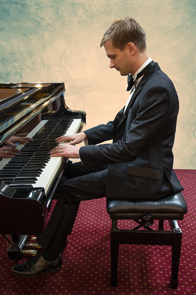 profile shot of Joshua at the piano